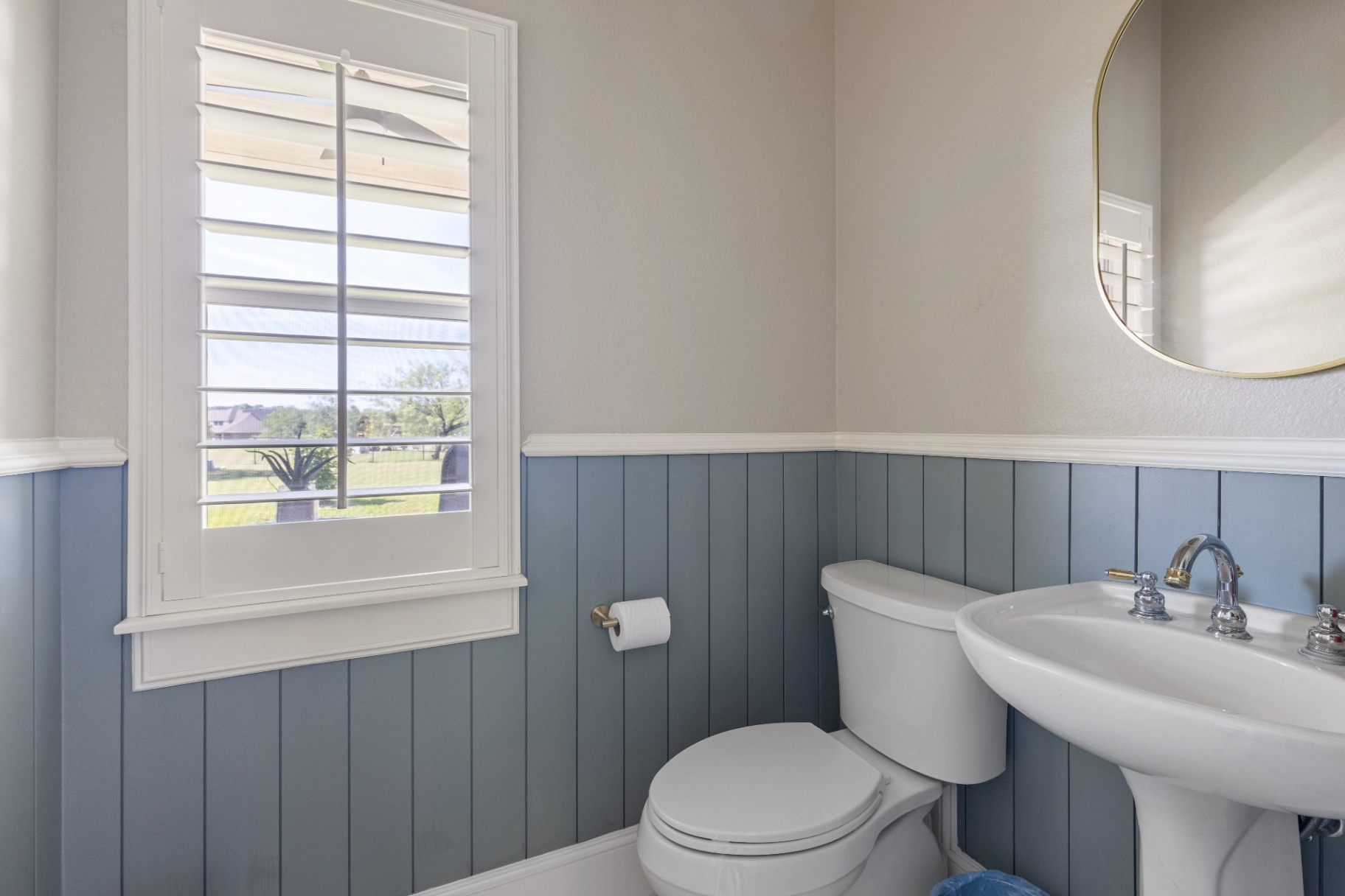 Powder room with blue shiplap wainscoting