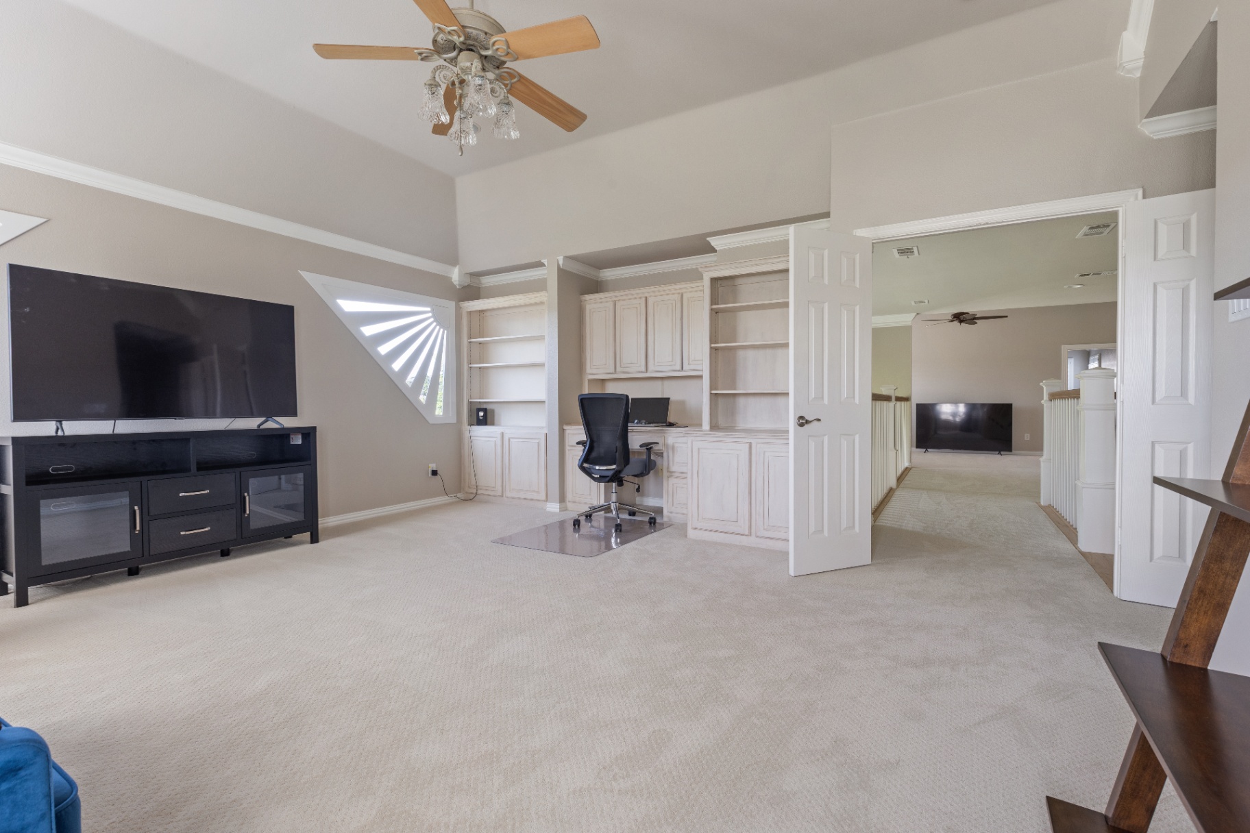 Upstairs loft with built-in office cabinetry