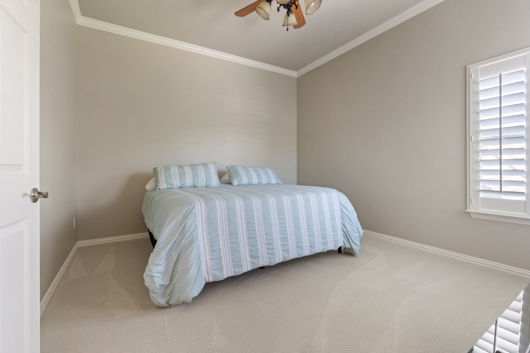 Guest bedroom with plantation shutters