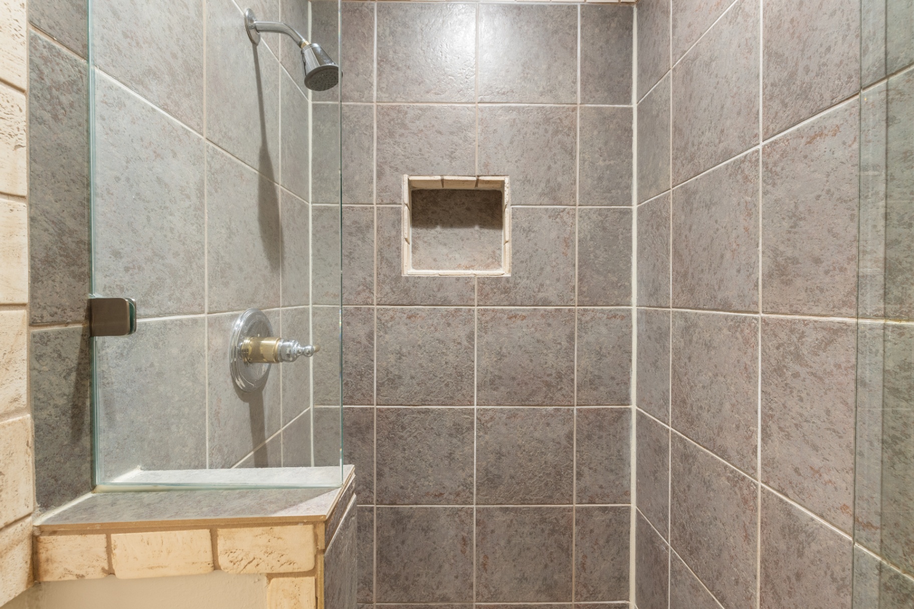 Secondary walk-in shower with travertine